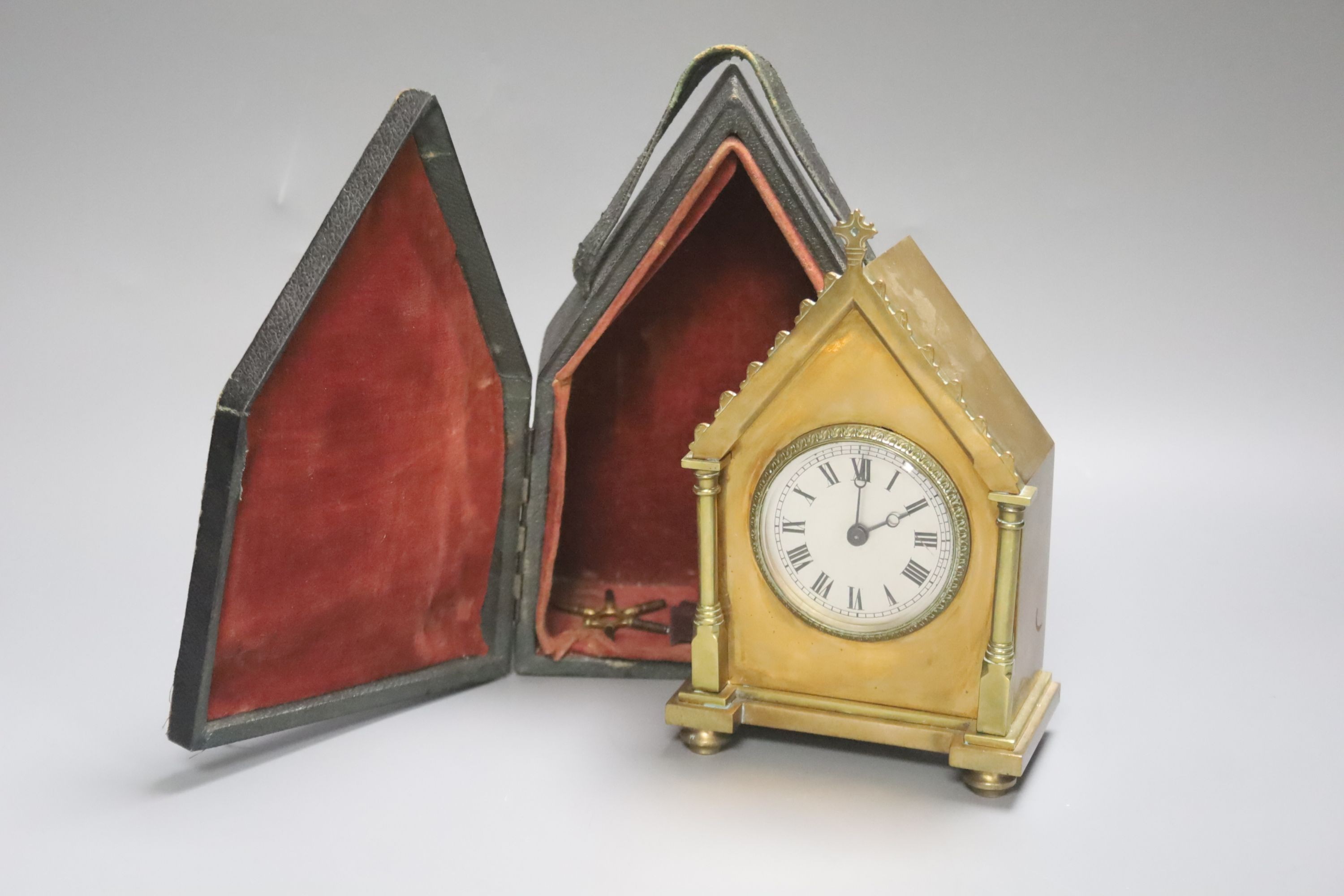 A late 19th century French Gothic brass cased carriage timepiece, with felt-lined carrying case, 16cm high, 11cm wide.